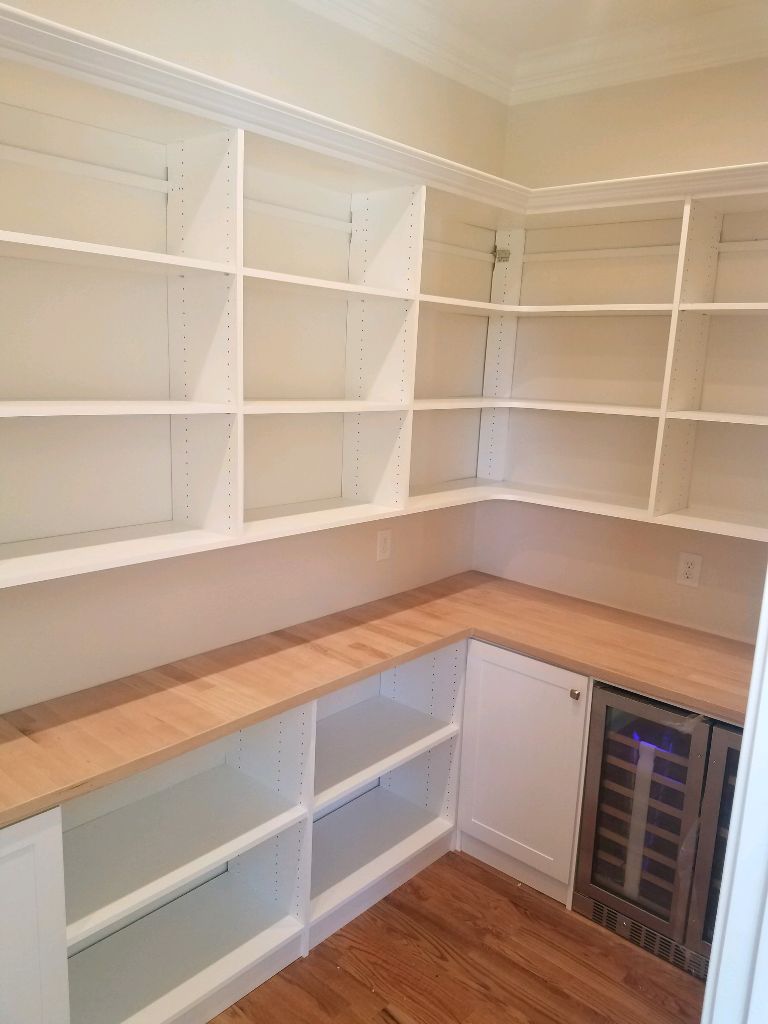 Empty corner shelving and countertop in a room.