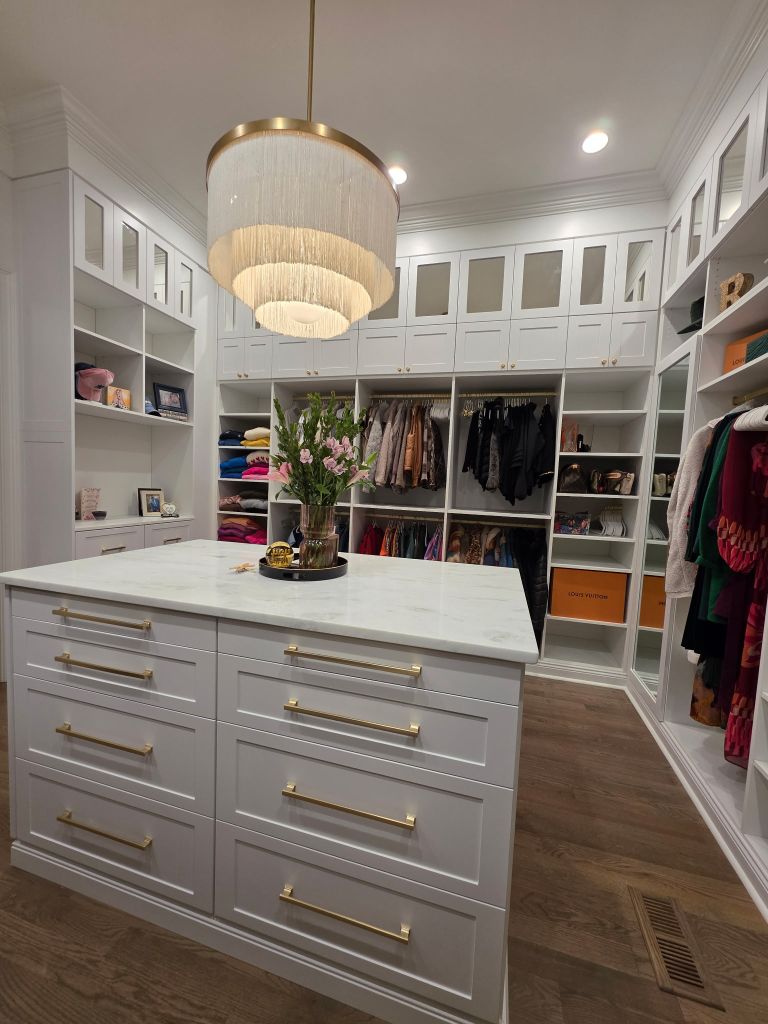 Luxurious walk-in closet with ample storage and elegant lighting.