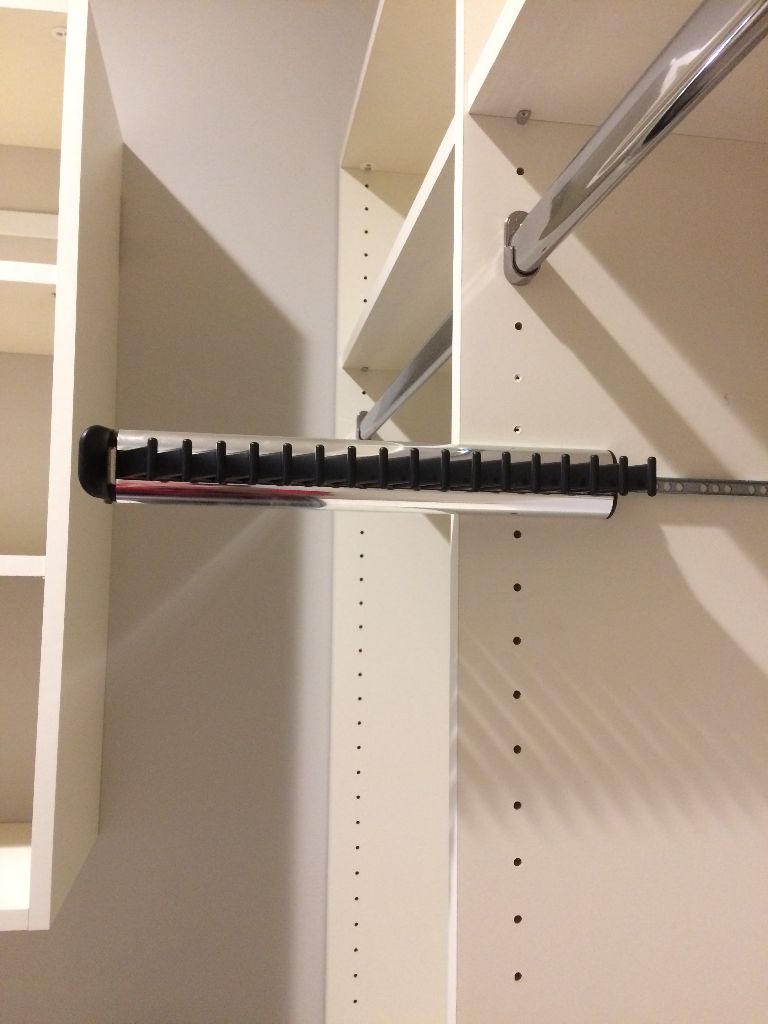 A close-up of a drawer slide installed inside a cabinet.
