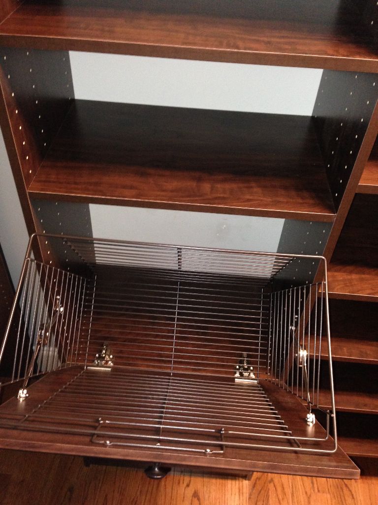 Empty wooden shelves and wire racks in a storage unit.