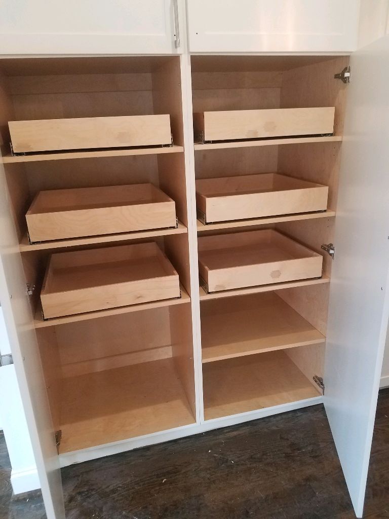 Empty wooden shelves and drawers in a cabinet unit.
